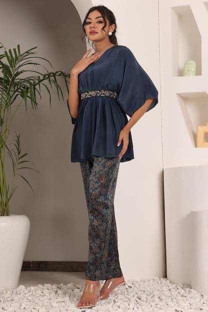 Blue pleated top with ajrakh pants and belt