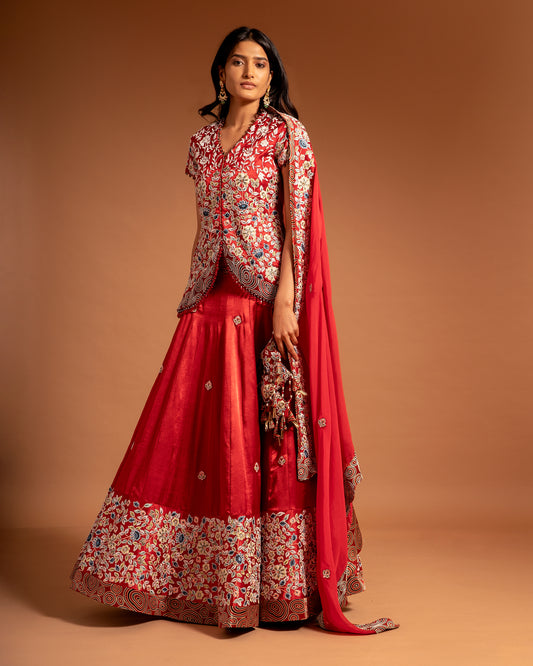 Red Lehenga and koti jacket with cape dupatta.