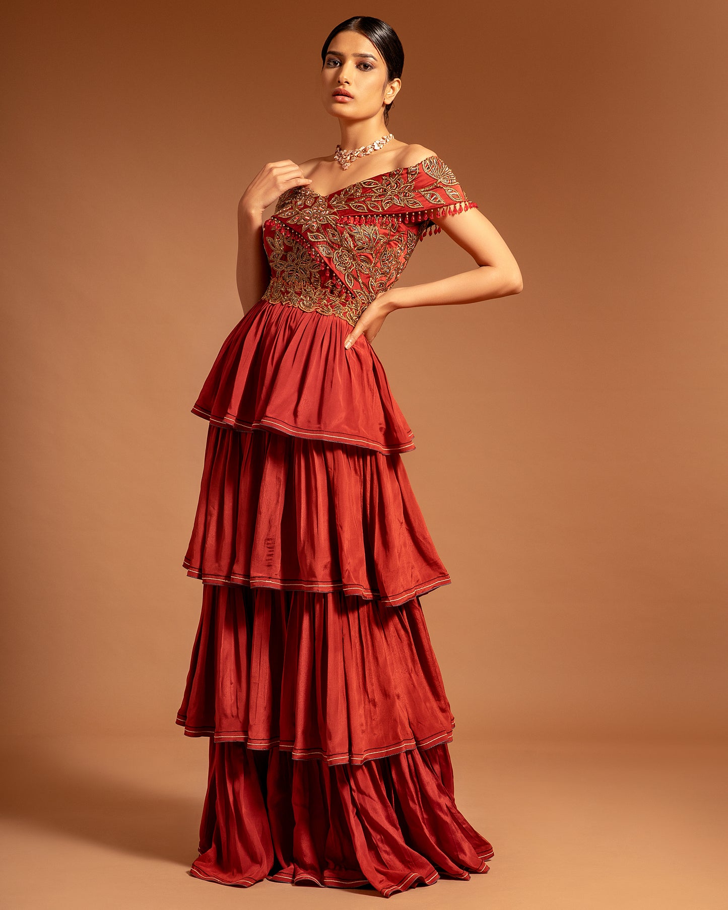 Maroon off shoulder layered Gown.