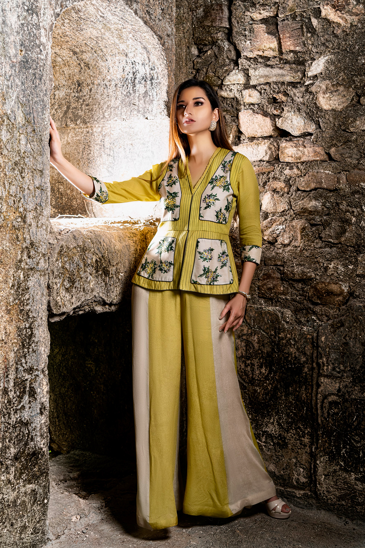 "Elevate your style with our ochre yellow peplum jumpsuit in crepe, featuring a chanderi bodice adorned with exquisite French knot and sequin detailing."