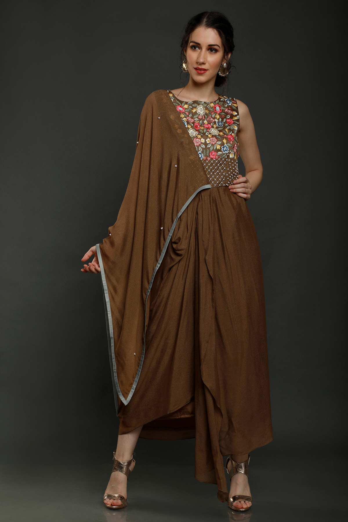 "Charming Tan Teddy Bear Crepe Dhoti Drape with Falling Pallu Sleeves, adorned with Thread, Cutdana, and Pearl Work Yoke. Shop this unique style!"
