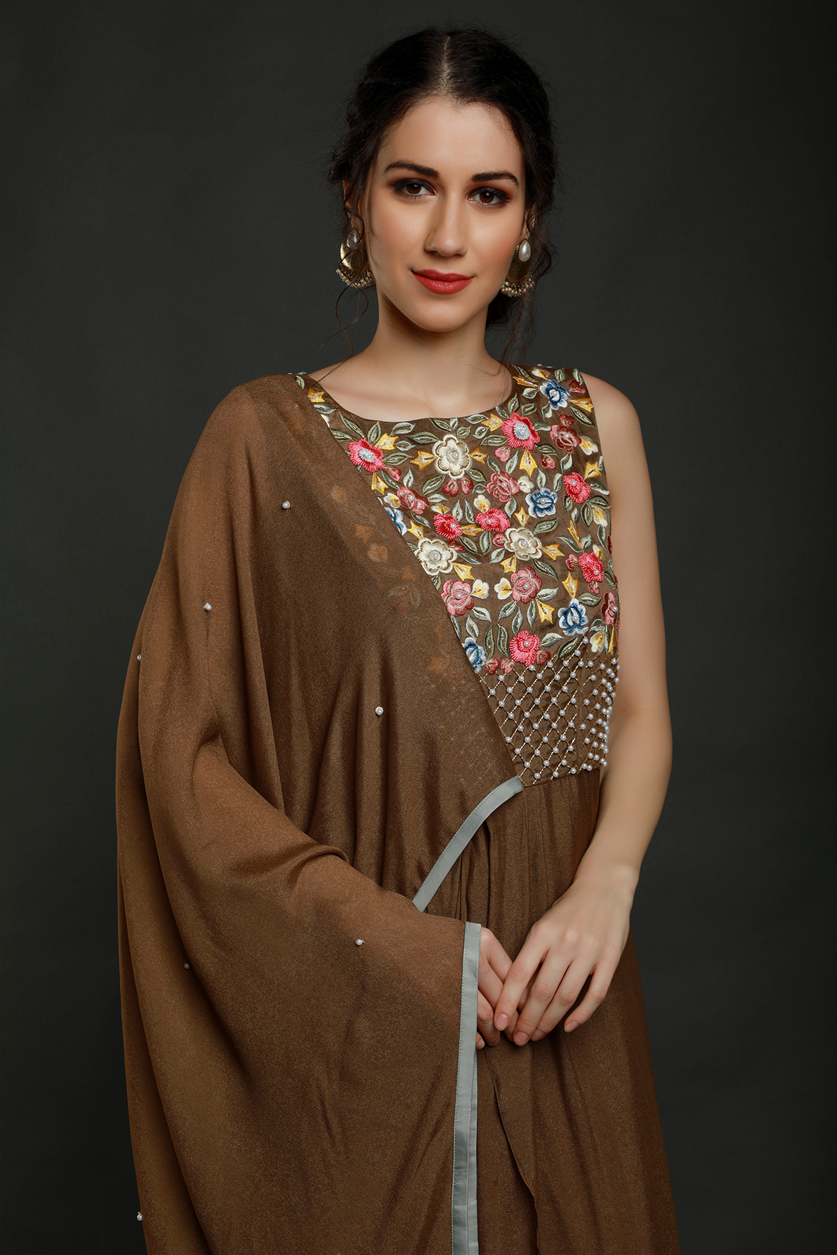 "Charming Tan Teddy Bear Crepe Dhoti Drape with Falling Pallu Sleeves, adorned with Thread, Cutdana, and Pearl Work Yoke. Shop this unique style!"