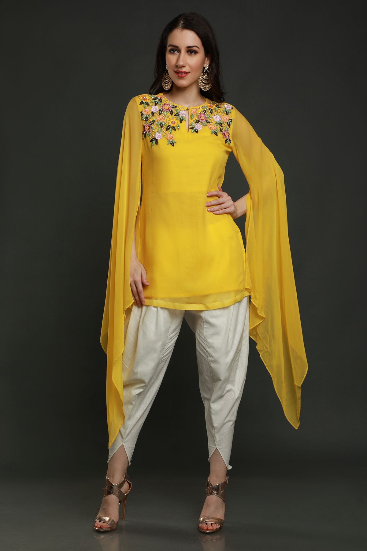 "Radiant Mango Yellow Georgette Kurta with Flared Sleeves, paired with White Dhoti adorned with Intricate Thread, Bead, and Cut Dana Embroidery."