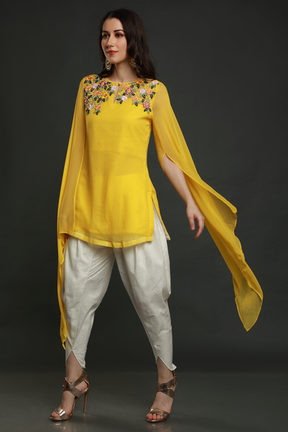 "Radiant Mango Yellow Georgette Kurta with Flared Sleeves, paired with White Dhoti adorned with Intricate Thread, Bead, and Cut Dana Embroidery."