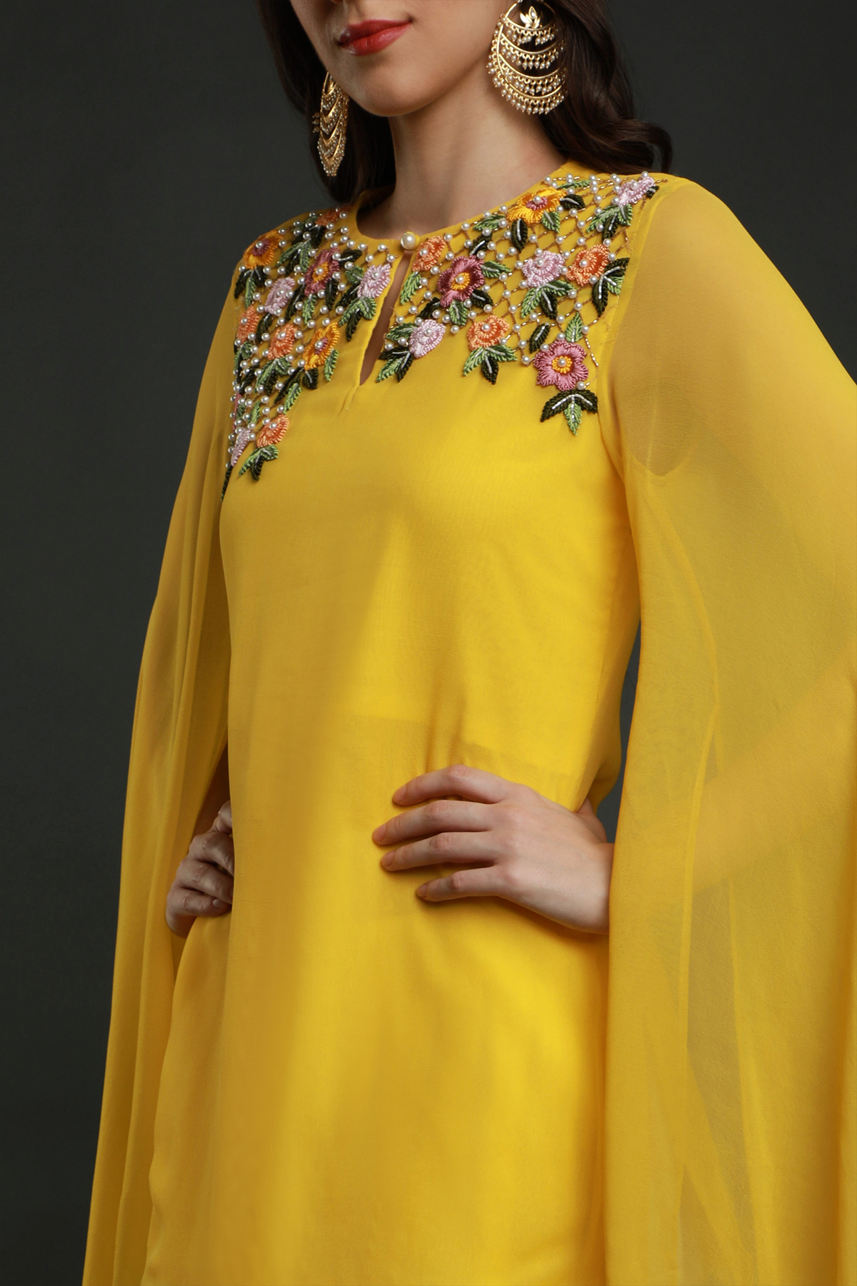 "Radiant Mango Yellow Georgette Kurta with Flared Sleeves, paired with White Dhoti adorned with Intricate Thread, Bead, and Cut Dana Embroidery."