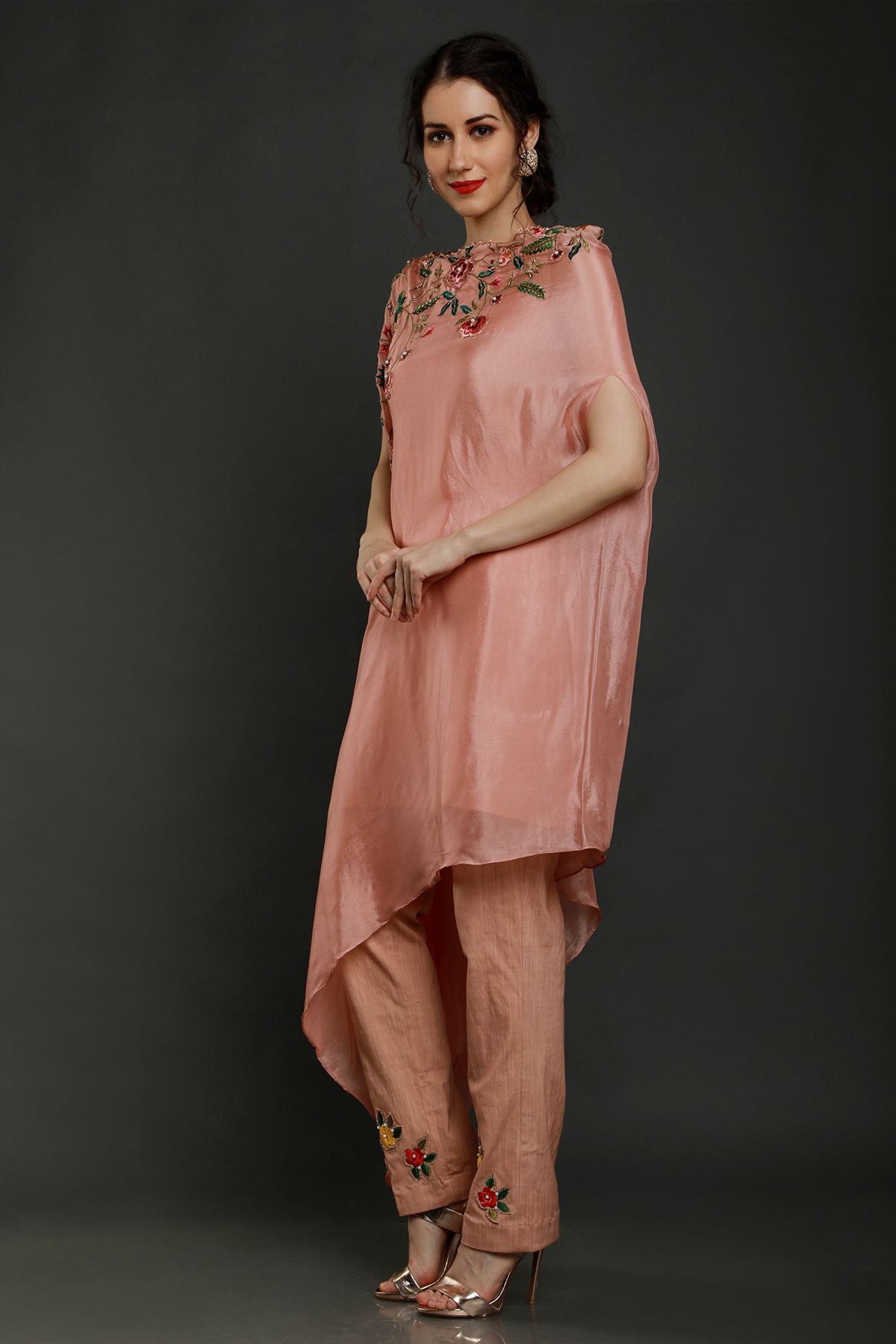 "Elegant peach crepe one-sided drape kaftan with thread, pearls & cutdana detailing, paired with stretch lycra pants - A stylish fusion outfit!"