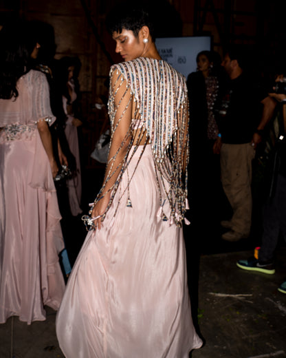 Peachy Pink ajrakh stripwork jacket paired up with Peachy pink bralette and drape dhoti skirt