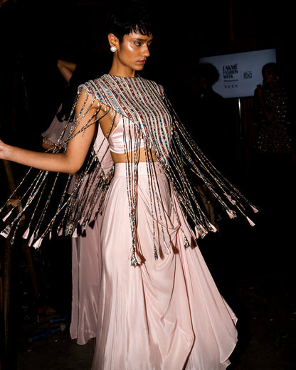 Peachy Pink ajrakh stripwork jacket paired up with Peachy pink bralette and drape dhoti skirt