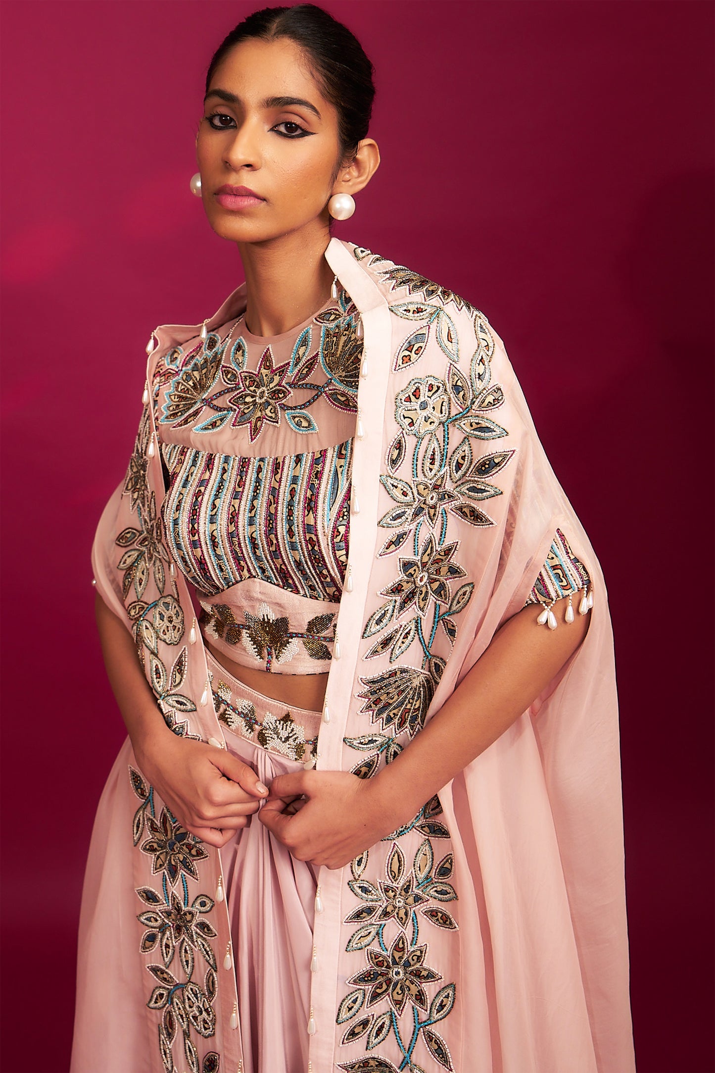 Peachy pink embellished ajrakh blouse with embroidered cape and dhoti