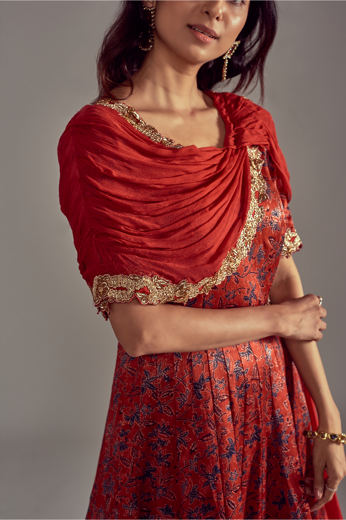 "Stunning Scarlet Red Mashru Silk Ajrakh Anarkali with Heavy Embroidered Border, enhanced with a Draped Dupatta and Belt for a regal look."
