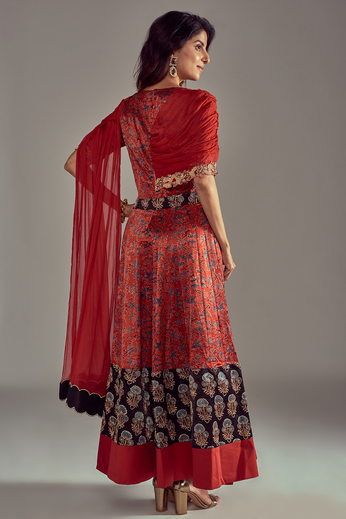 "Stunning Scarlet Red Mashru Silk Ajrakh Anarkali with Heavy Embroidered Border, enhanced with a Draped Dupatta and Belt for a regal look."