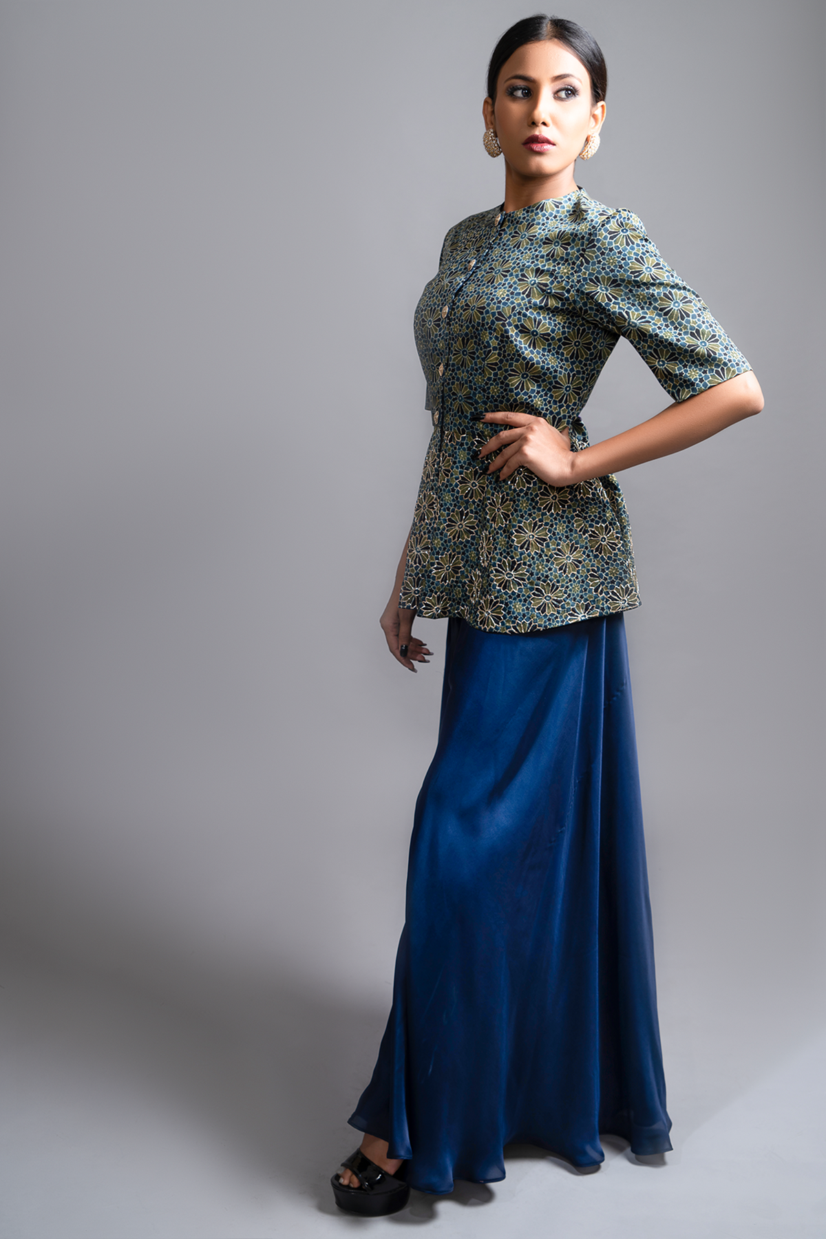 "Stunning Ajrakh Peplum Top in Pure Modal Silk, adorned with Intricate Nakshi and Zardosi work, beautifully paired with Blue Flared Pants in Pure Satin Crepe."