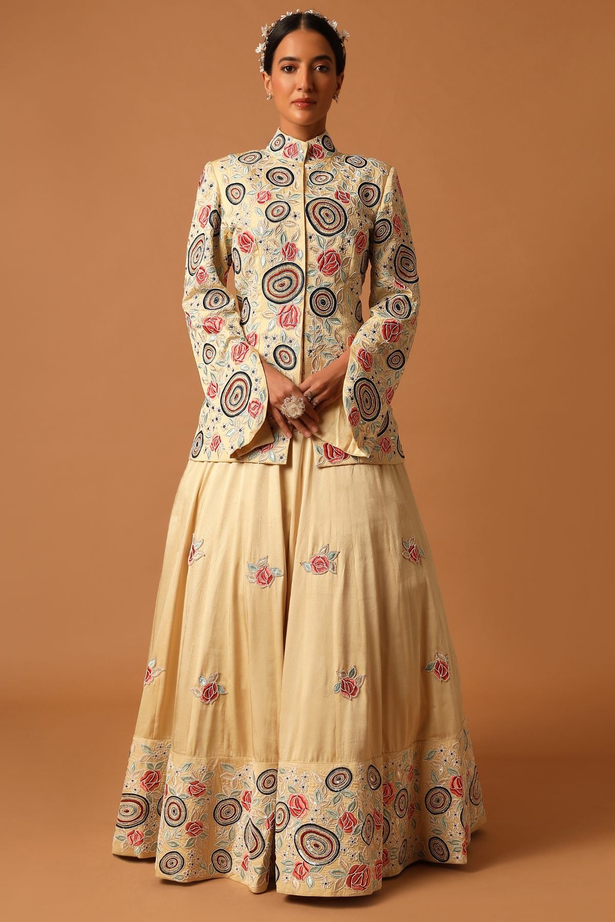 "Step into exquisite elegance with a fully embroidered short kurta, bordered lehenga, and a ruffled organza dupatta. Explore timeless beauty!"