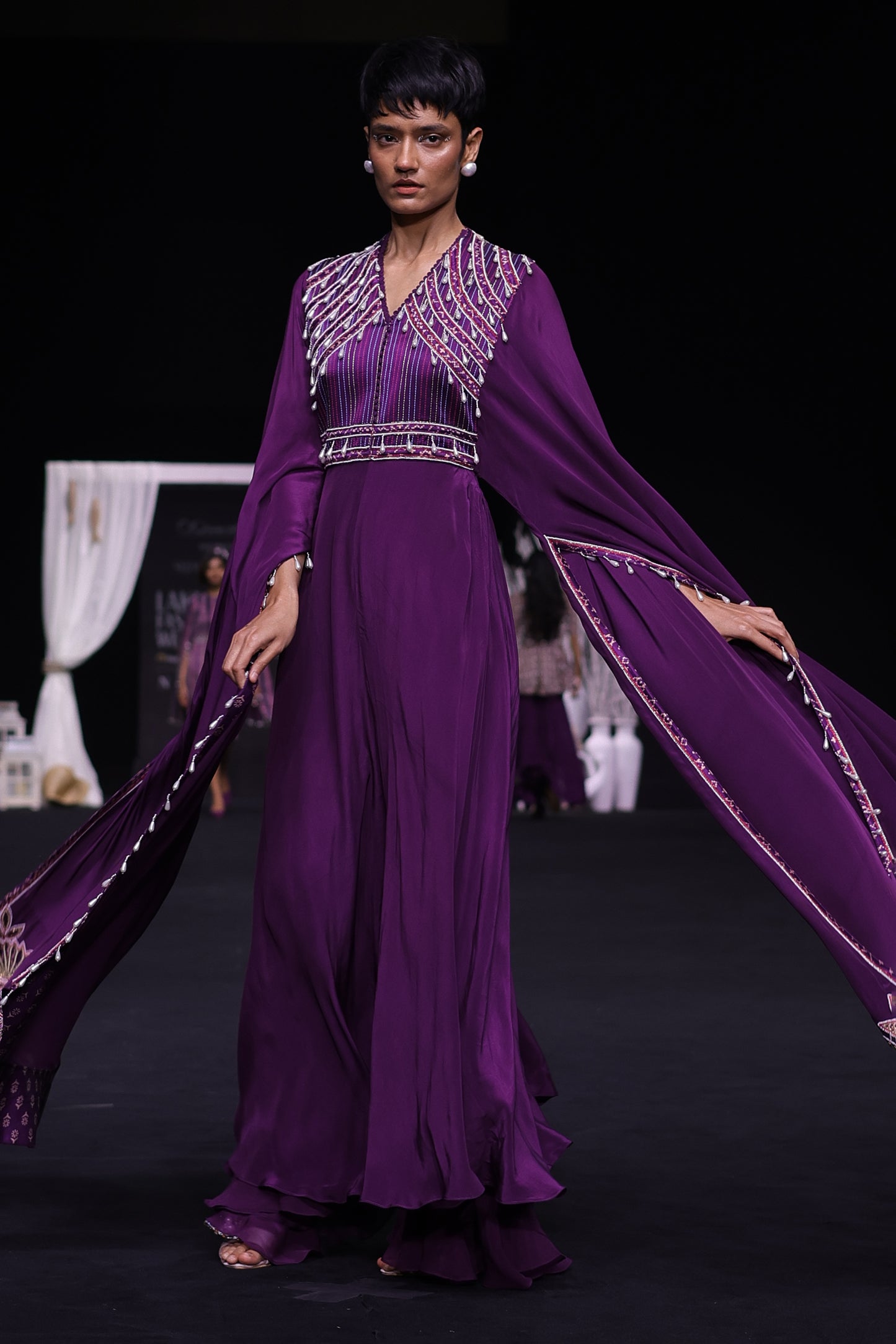 Purple heavily embellished jumpsuit wiwth embroidered cape sleeves