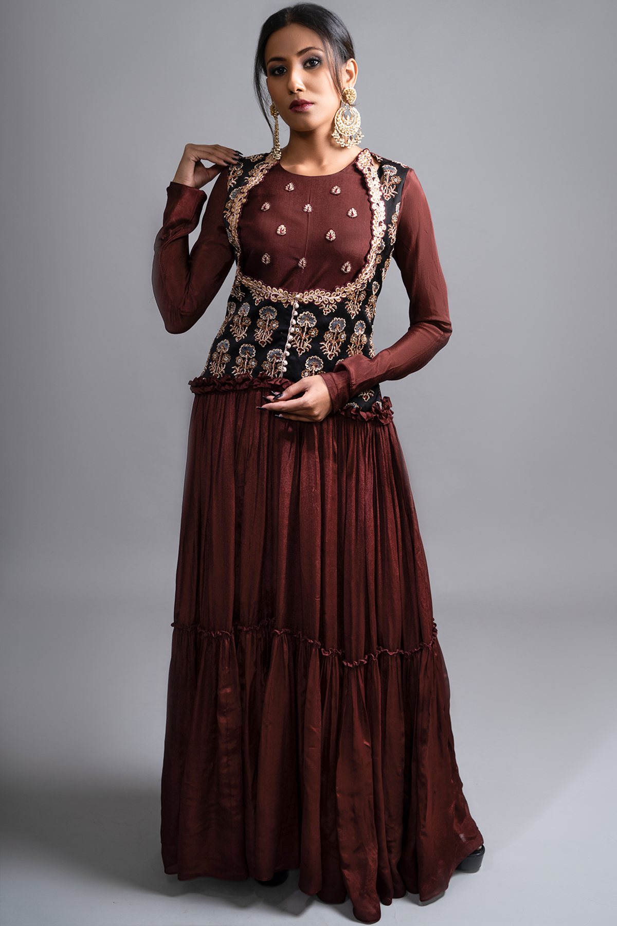 "Mesmerizing Maroon Pleated Gown paired with a Waist Koti Style Ajrak Jacket in Mashru Silk, adorned with intricate and beautiful work. Embrace the allure!"