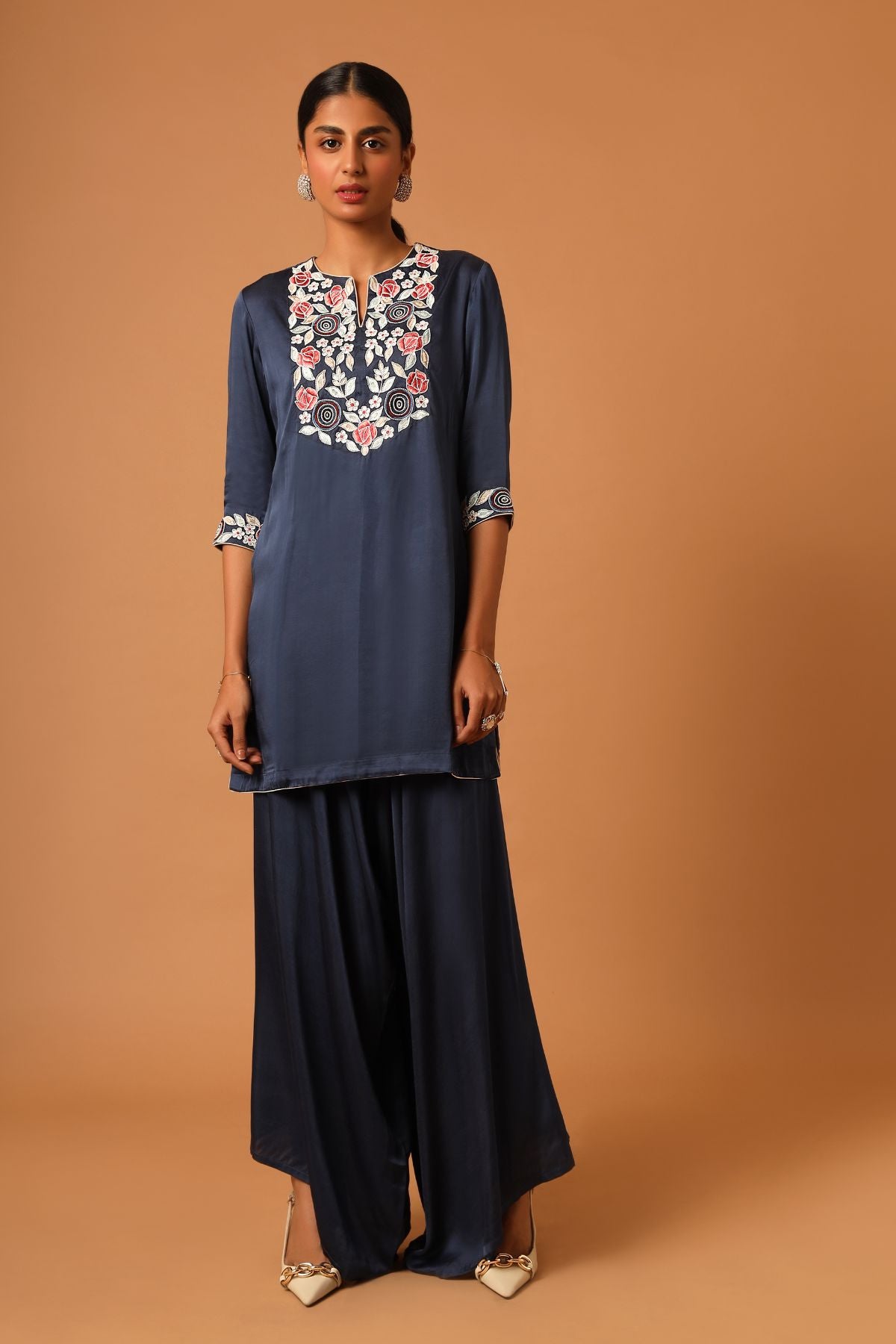 "Elevate your style with our finely handcrafted short kurti paired up with trendy asymmetrical pants. Perfect for a chic and unique look. Shop now!"