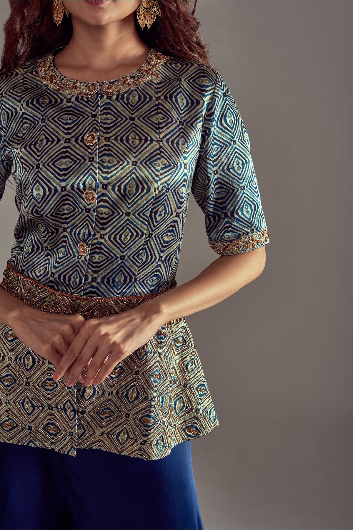 Light Teal Green Peplum Top in Pure Ajrakh Mashru Silk, beautifully adorned with Intricate Hand Detailing. can paired with Blue Flared Pants in Pure Satin Crepe