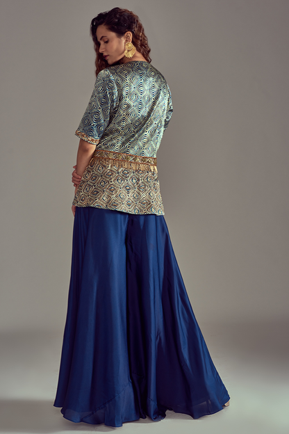 Light Teal Green Peplum Top in Pure Ajrakh Mashru Silk, beautifully adorned with Intricate Hand Detailing. can paired with Blue Flared Pants in Pure Satin Crepe