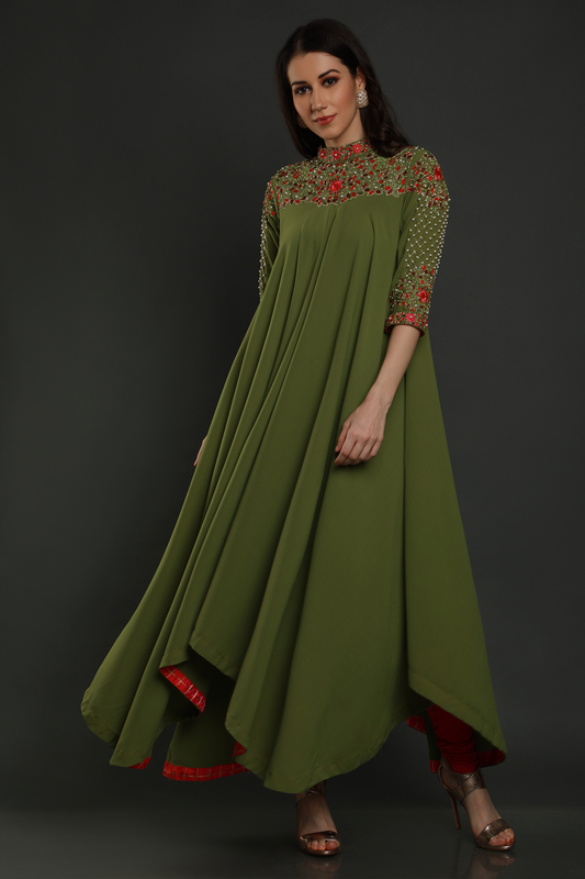 Elevate your elegance in a Mehendi Green Moss Crepe asymmetric maxi dress. Hand-embroidered with thread, pearls, and cut dana work for a unique flair.