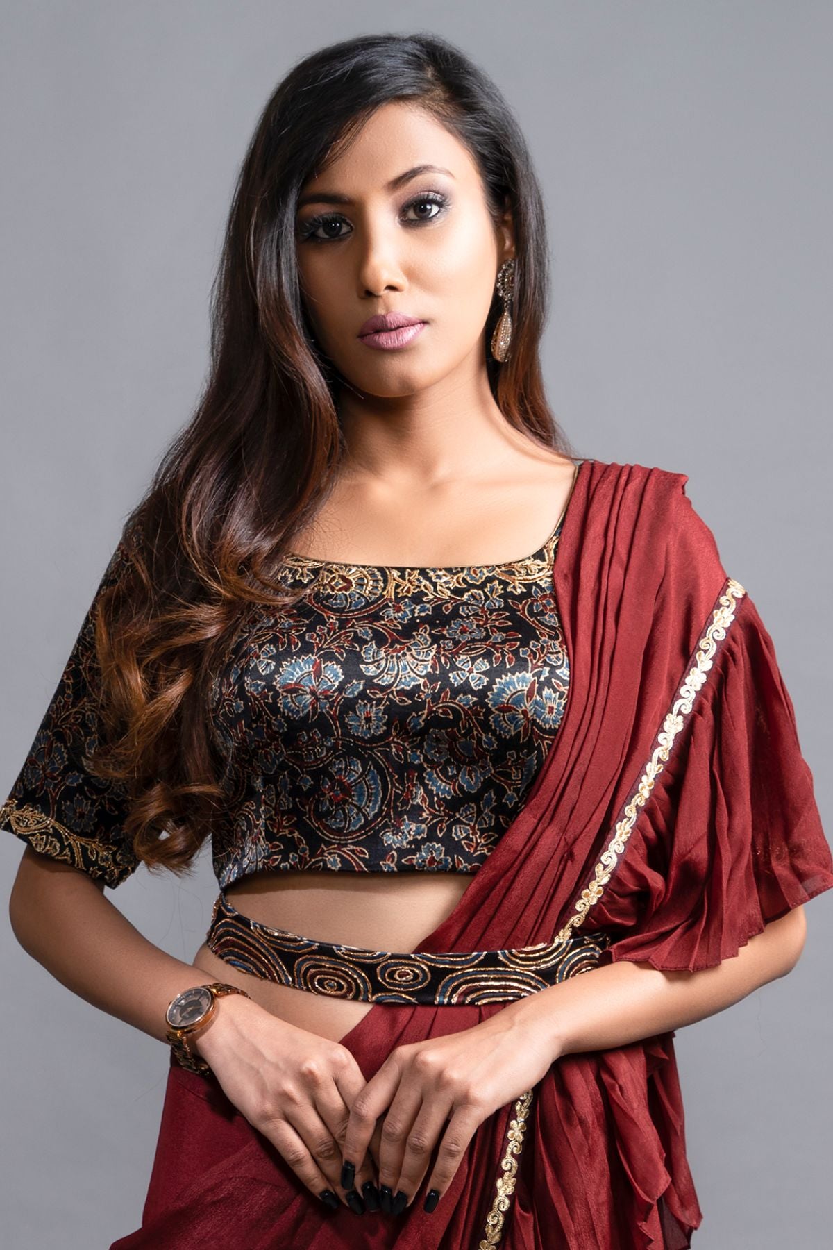 "Graceful Maroon Ruffled Saree paired with an Ajrakh Printed Blouse, featuring Intricate Embroidery in Mashru Silk. Fully Handcrafted Ajrakh Waistbelt."