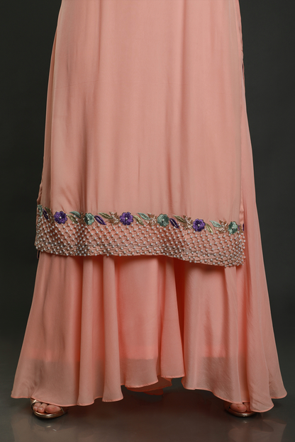 "Chic peach kurta with threadwork, sequins, cutpipe, & bead embellishments, paired with umbrella garara & shaded chiffon dupatta - A stylish fusion outfit!"