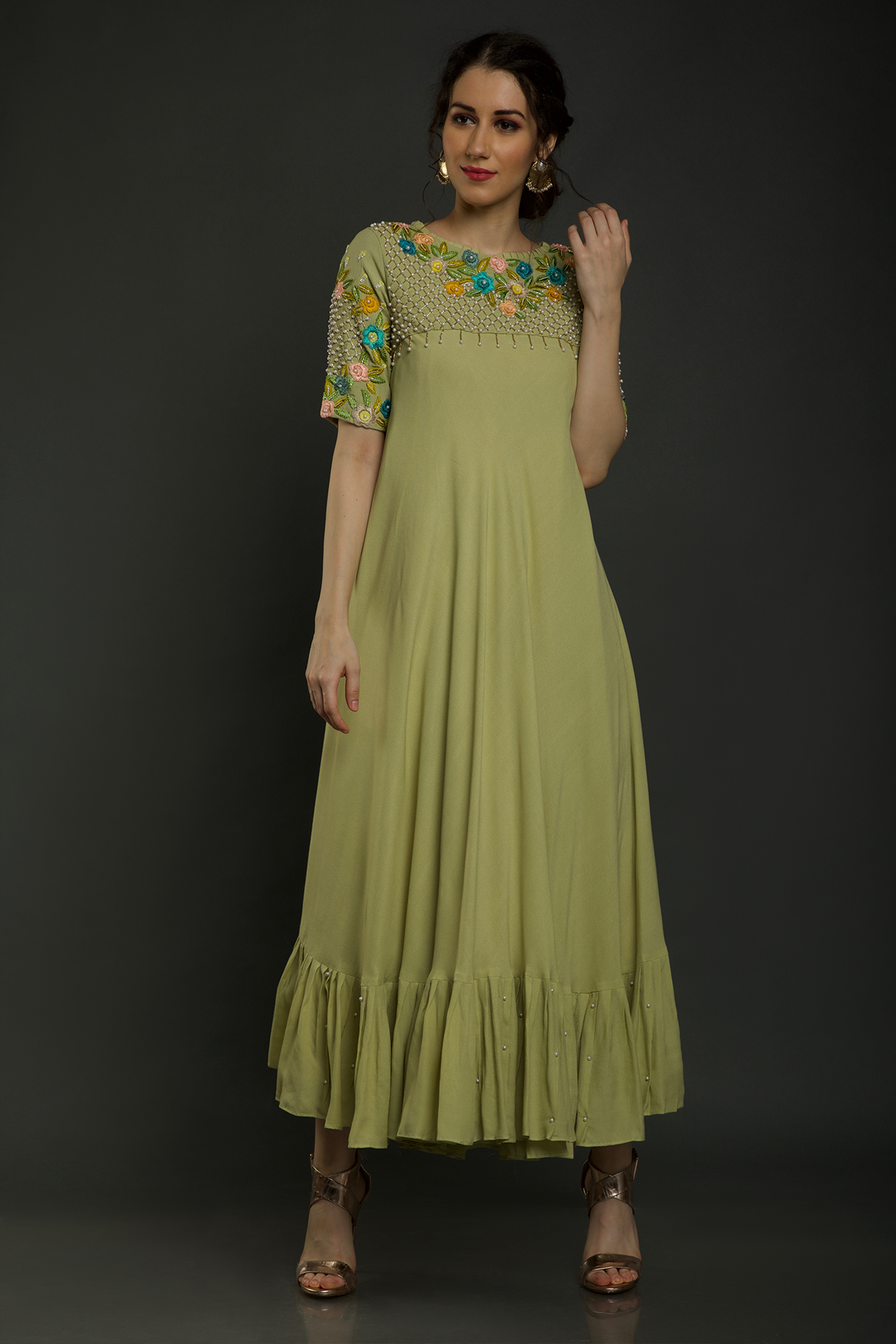 Radiate freshness in our Lime Green Umbrella Dress. Moss crepe with intricate embroidered yoke featuring knot work thread, pearl beads, & cutdana embellishments