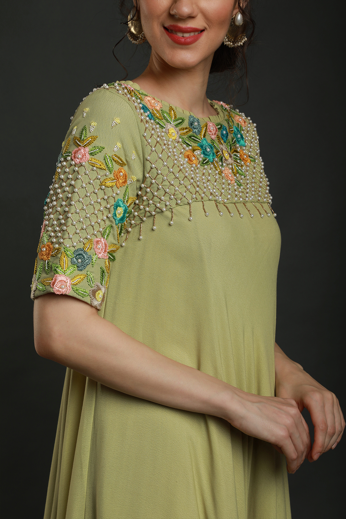 Radiate freshness in our Lime Green Umbrella Dress. Moss crepe with intricate embroidered yoke featuring knot work thread, pearl beads, & cutdana embellishments