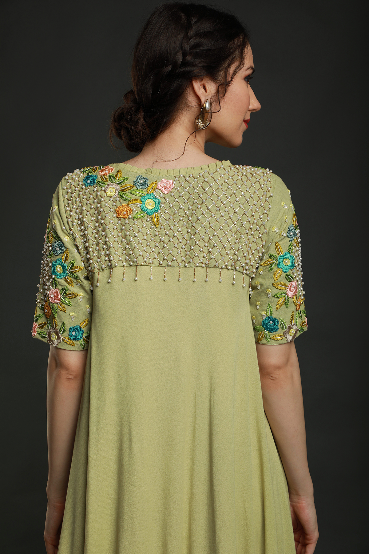 Radiate freshness in our Lime Green Umbrella Dress. Moss crepe with intricate embroidered yoke featuring knot work thread, pearl beads, & cutdana embellishments