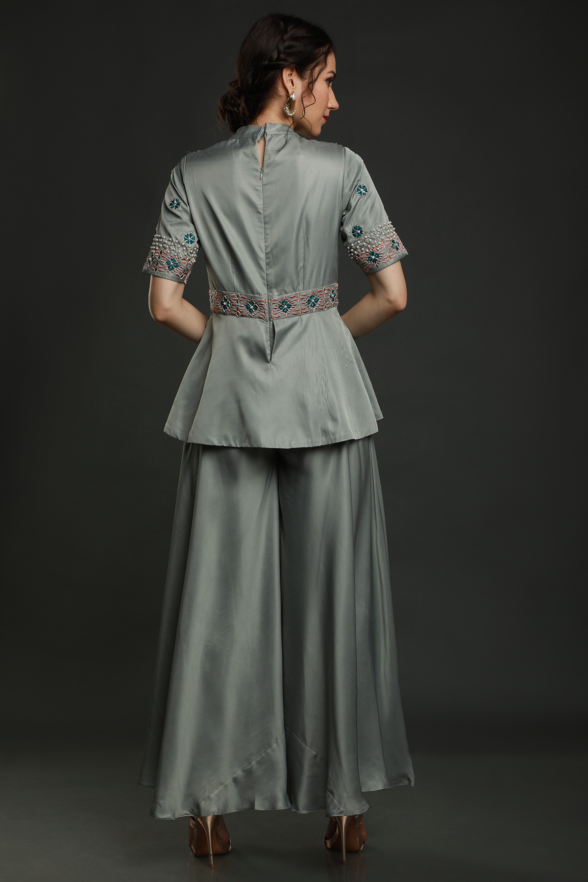 Discover elegance in our Dark Clay Grey satin crepe peplum jumpsuit, adorned with exquisite hand embroidery. Convertible into a top and bottom set.