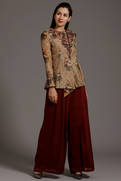 Elevate your style with this Beige & Wine Chanderi peplum Angrakha top and pleated crepe palazzo pants set. Exquisite hand-embroidery adds charm.