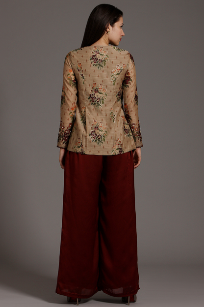 Elevate your style with this Beige & Wine Chanderi peplum Angrakha top and pleated crepe palazzo pants set. Exquisite hand-embroidery adds charm.