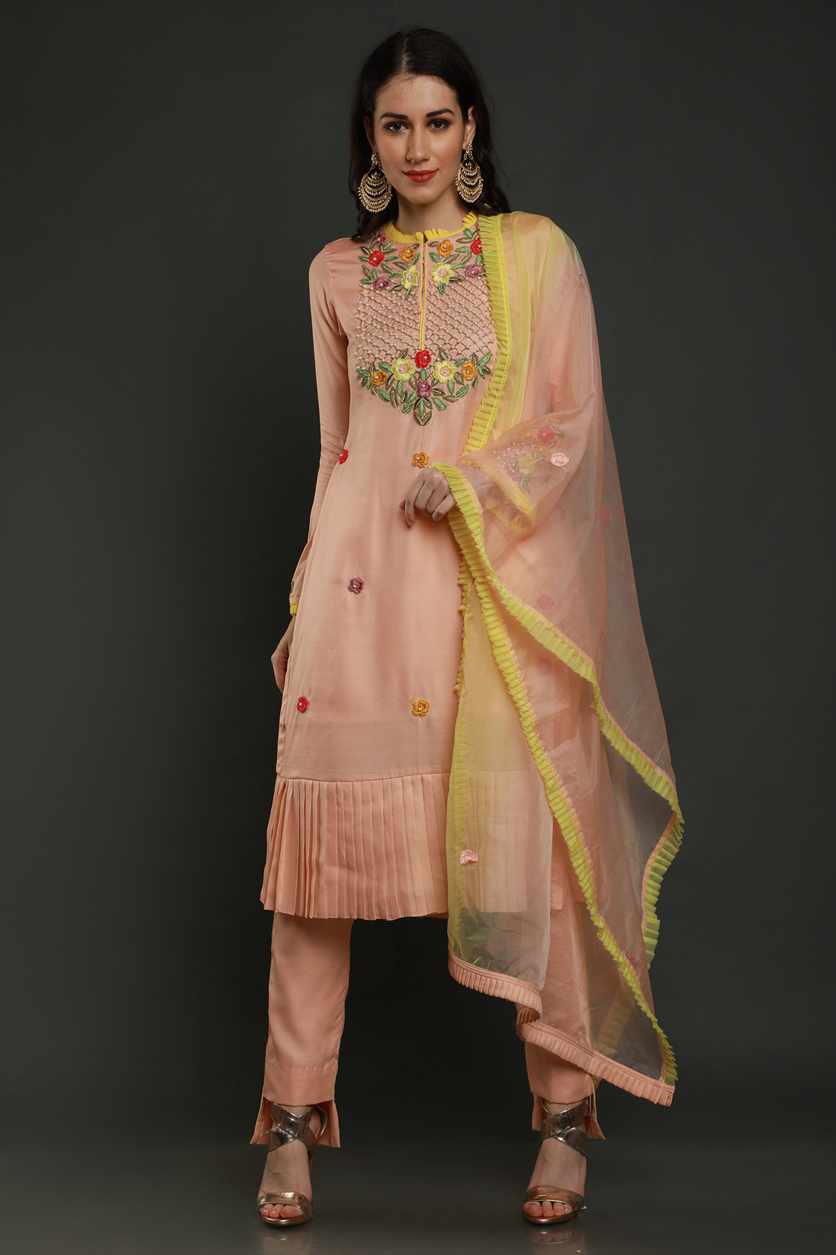 "Elegant peach crepe silk pleated hem kurta with intricate thread embroidery, bead & cutdana work. Paired with peach pants & organza dupatta - A graceful ensemble!"