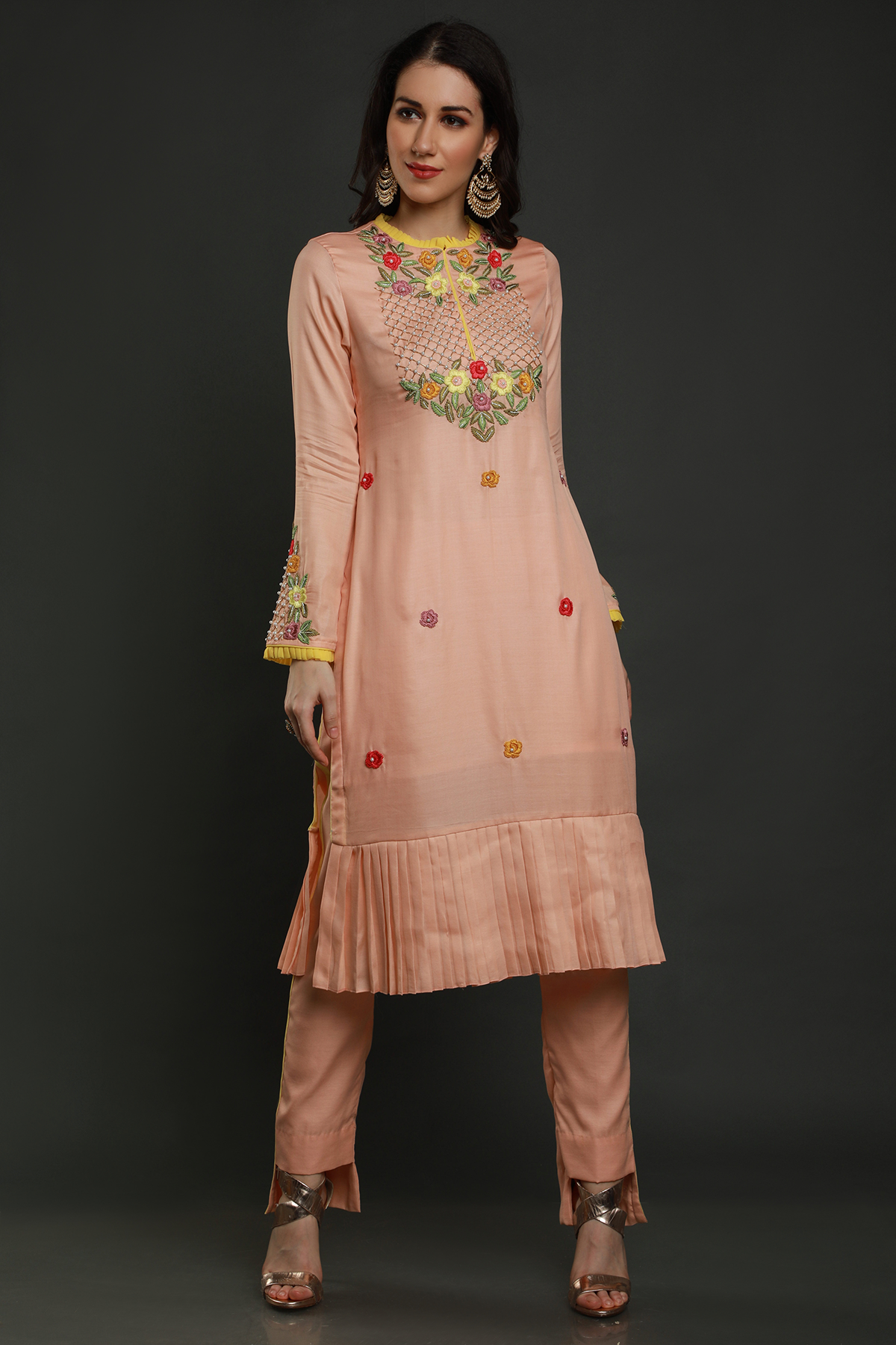 "Elegant peach crepe silk pleated hem kurta with intricate thread embroidery, bead & cutdana work. Paired with peach pants & organza dupatta - A graceful ensemble!"