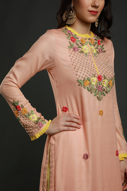 "Elegant peach crepe silk pleated hem kurta with intricate thread embroidery, bead & cutdana work. Paired with peach pants & organza dupatta - A graceful ensemble!"