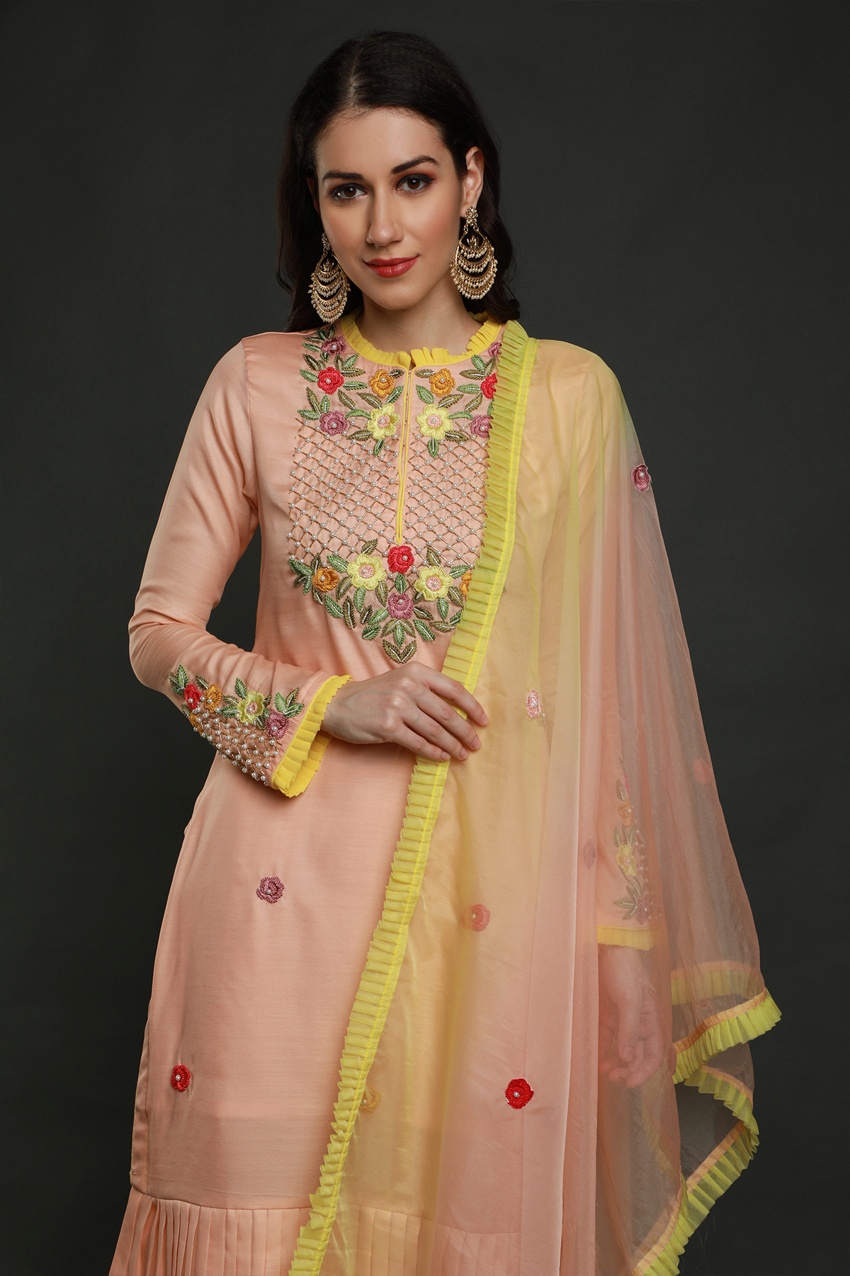 "Elegant peach crepe silk pleated hem kurta with intricate thread embroidery, bead & cutdana work. Paired with peach pants & organza dupatta - A graceful ensemble!"