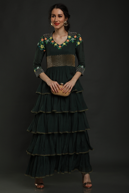 Elegance meets allure in our Bottle Green Layered Ankle Length Dress. Thread work, cutdana, and pearl embellishments on yoke and sleeves add enchanting charm.