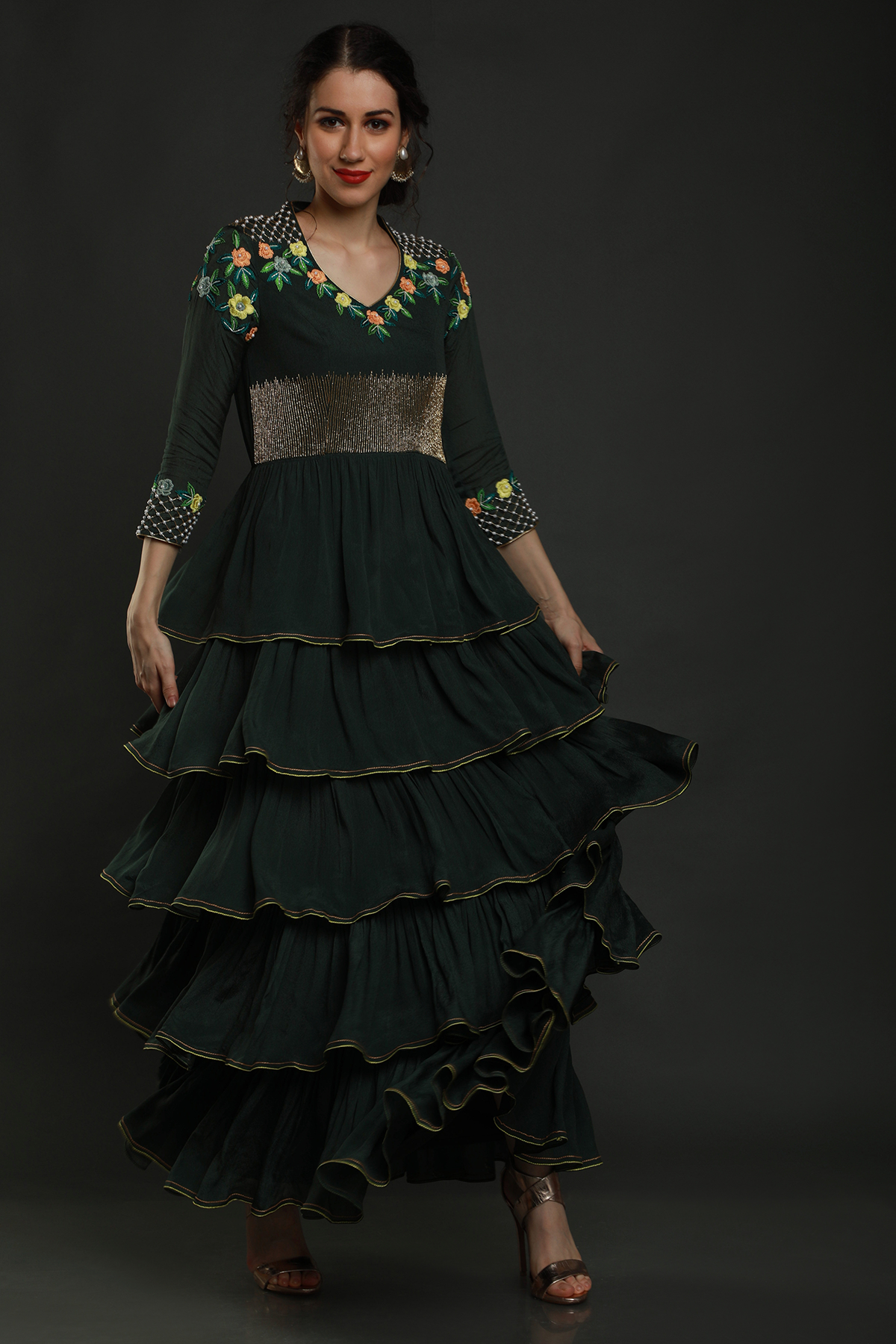 Elegance meets allure in our Bottle Green Layered Ankle Length Dress. Thread work, cutdana, and pearl embellishments on yoke and sleeves add enchanting charm.