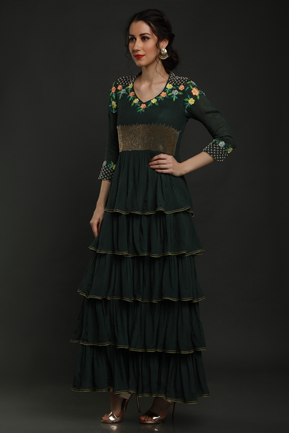 Elegance meets allure in our Bottle Green Layered Ankle Length Dress. Thread work, cutdana, and pearl embellishments on yoke and sleeves add enchanting charm.